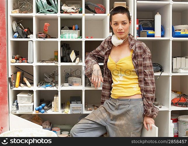 Young Woman by Tool Shelves