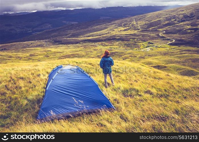 Young woman camping in the mountains