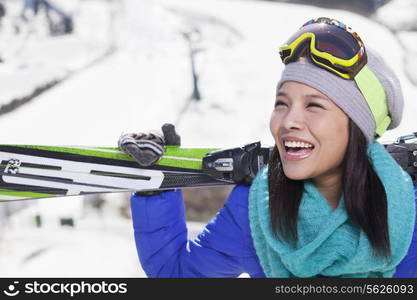 Young Woman Carrying Her Skis