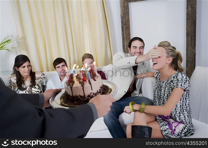 Young woman celebrating a birthday party with her friends
