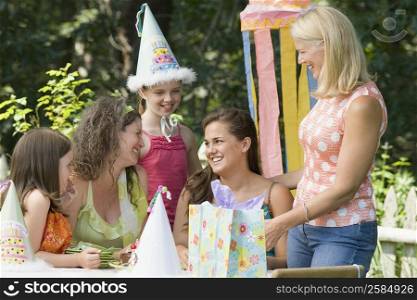 Young woman celebrating her birthday with her family and friends