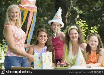 Young woman celebrating her birthday with her family and friends