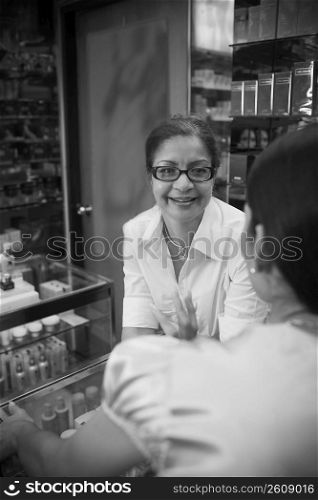 Young woman chatting with beauty consultant in shop