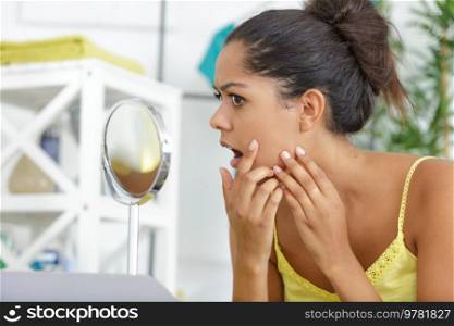 young woman checking her skin