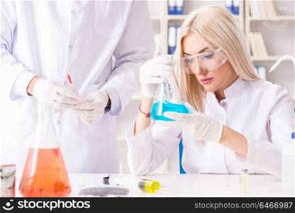 Young woman chemist working in clinic lab