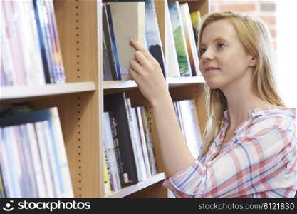 Young Woman Choosing A Book In Bookstore