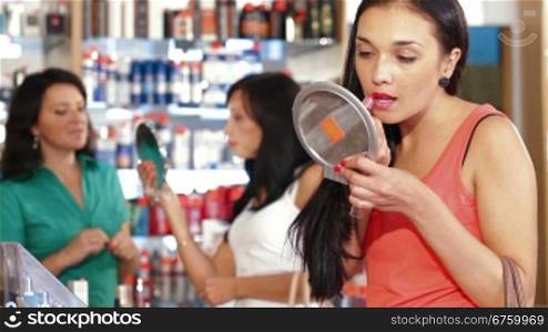 Young woman choosing and buying cosmetics in the beauty shop