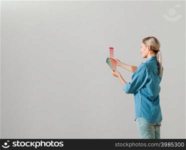 Young woman choosing paint color