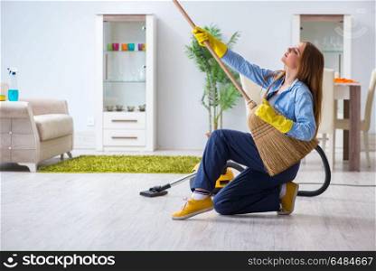 Young woman cleaning floor at home doing chores