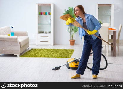 Young woman cleaning floor at home doing chores