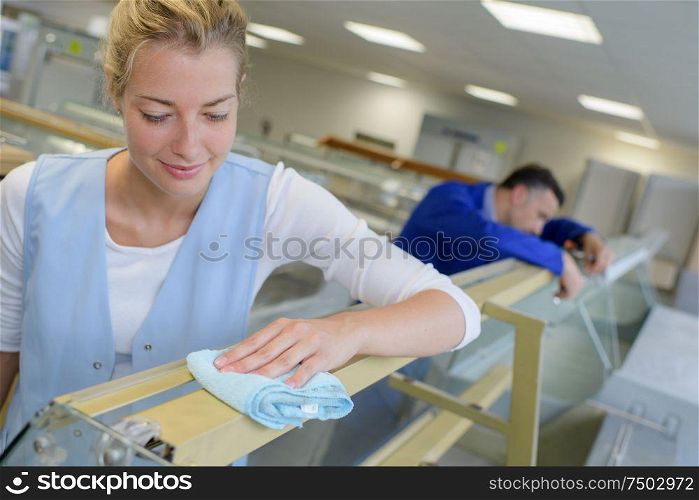 young woman cleaning office