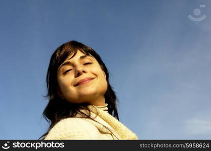 young woman close up portrait enjoying the sun