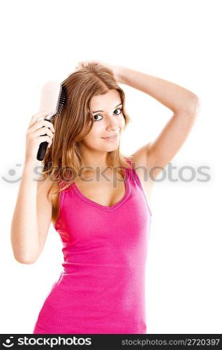 Young woman combs hair