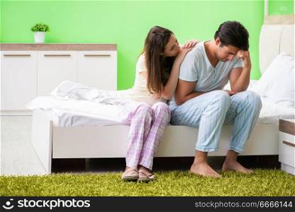 Young woman consoling disappointed impotent husband . The young woman consoling disappointed impotent husband