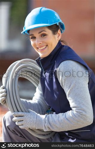 young woman construction worker with wires