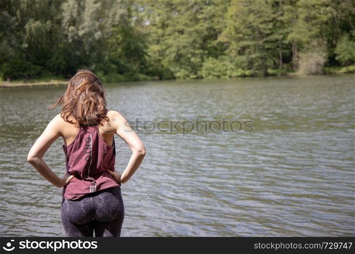 Young woman contemplating at a lake