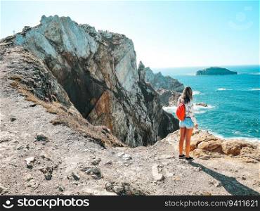 Young woman contemplating the cliffs in Asturias, Spain