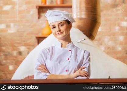 Young woman cook. Image of young woman cook standing at kitchen