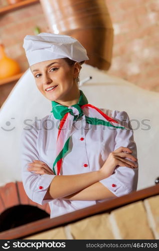 Young woman cook. Image of young woman cook standing at kitchen