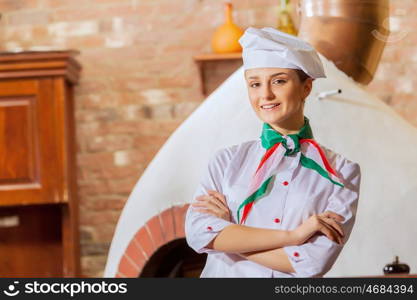 Young woman cook. Image of young woman cook standing at kitchen