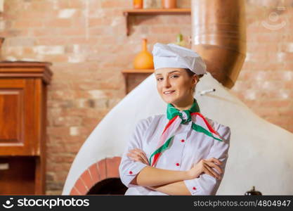 Young woman cook. Image of young woman cook standing at kitchen