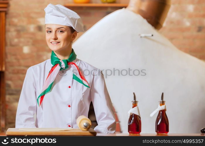 Young woman cook. Image of young woman cook standing at kitchen