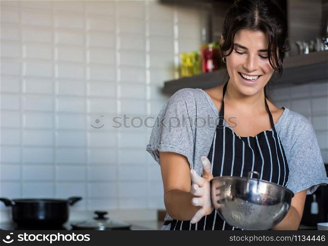 Young Woman Cooking in the kitchen at home. Healthy Food.