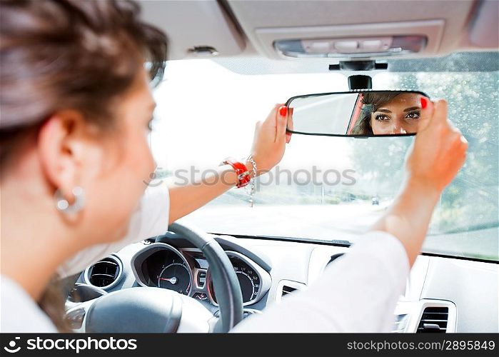 Young woman corrected rear view mirror