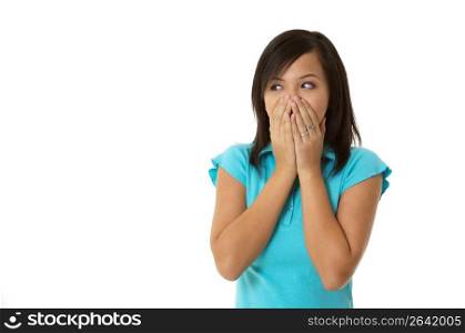 Young woman covering mouth with hands