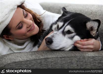 young woman cuddling her dog