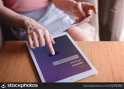 Young Woman Customer using Credit Card and Tablet to Payment Online. Close-up shot and Selective focus