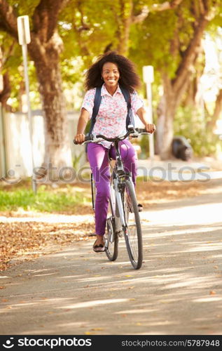 Young Woman Cycling Along Street To Work