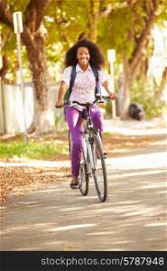 Young Woman Cycling Along Street To Work