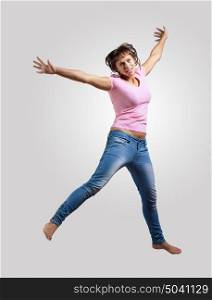 young woman dancing and jumping.... pretty modern slim hip-hop style woman jumping dancing on a colour background
