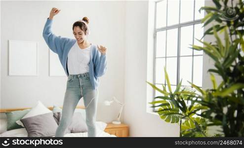 young woman dancing home
