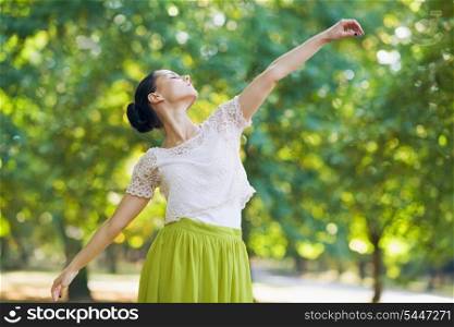 Young woman dancing in park
