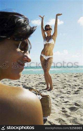 Young woman dancing on beach