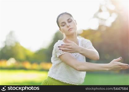 Young woman dancing on meadow