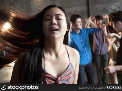 Young woman dancing with her eyes closed