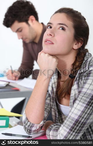 Young woman daydreaming in class