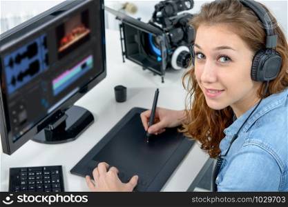 young woman designer using a graphics tablet for video editing