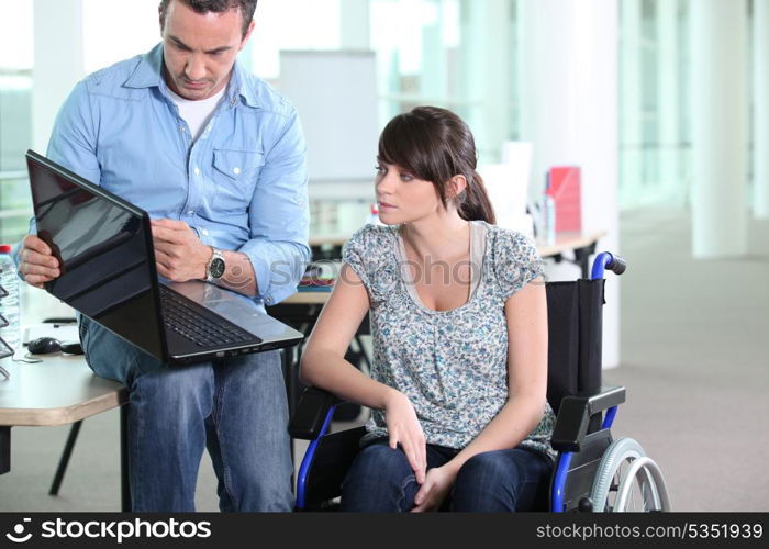Young woman disabled with co-worker