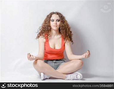 young woman do yoga meditation on white background her eyes closed