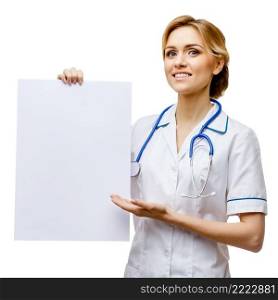 Young woman doctor isolated on white background holding blanc sign. Woman doctor standing on white background
