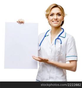 Young woman doctor isolated on white background holding blanc sign. Woman doctor standing on white background