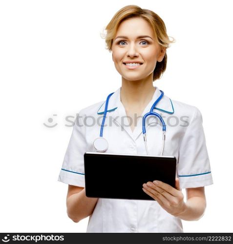 Young woman doctor isolated on white background holding tablet pc. Woman doctor standing on white background