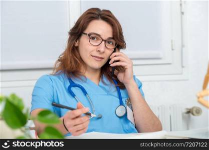 young woman doctor talking on the phone