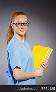Young woman doctor with book