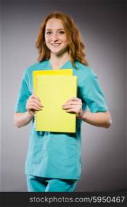 Young woman doctor with book