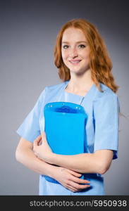 Young woman doctor with book